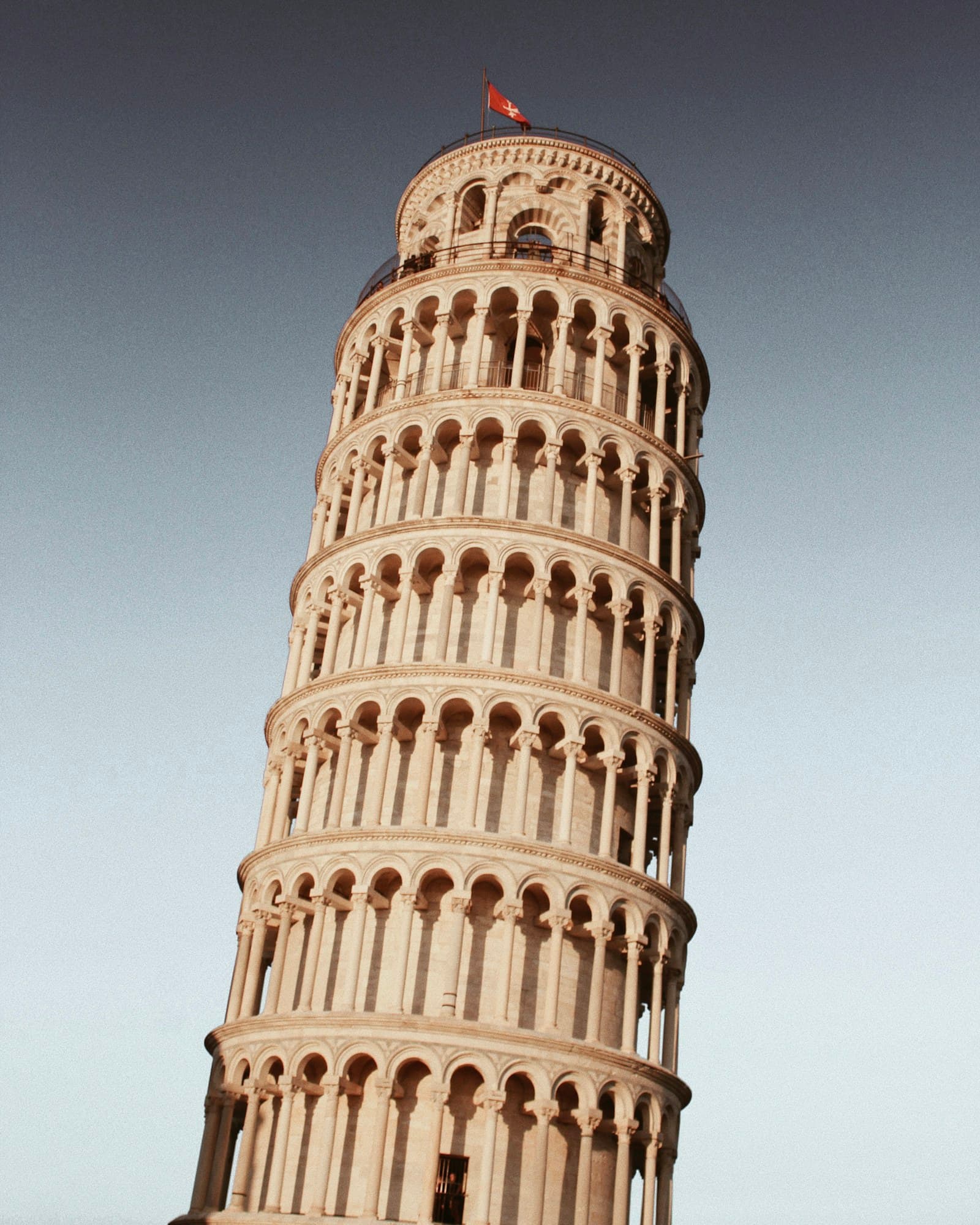 The Leaning Tower of Pisa against a clear blue sky